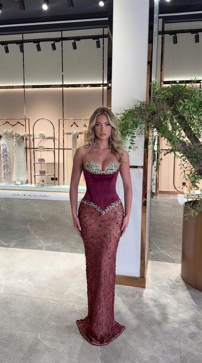Front view of burgundy wine red strapless corset beaded evening dress