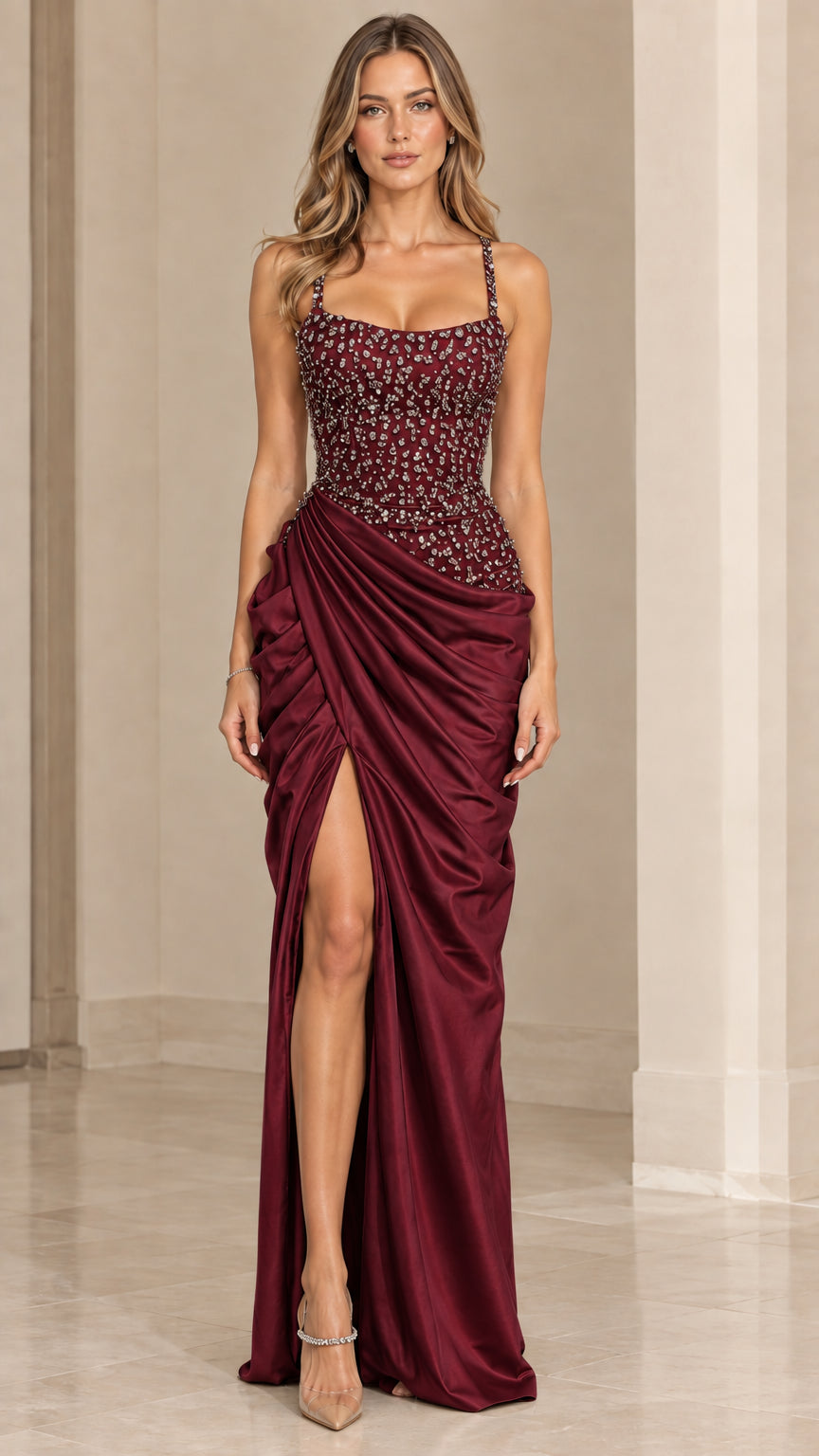 Model wearing deep burgundy red ruched satin formal dress