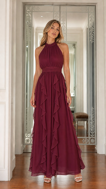Full front view of model wearing burgundy halter neck cascading ruffle maxi dress