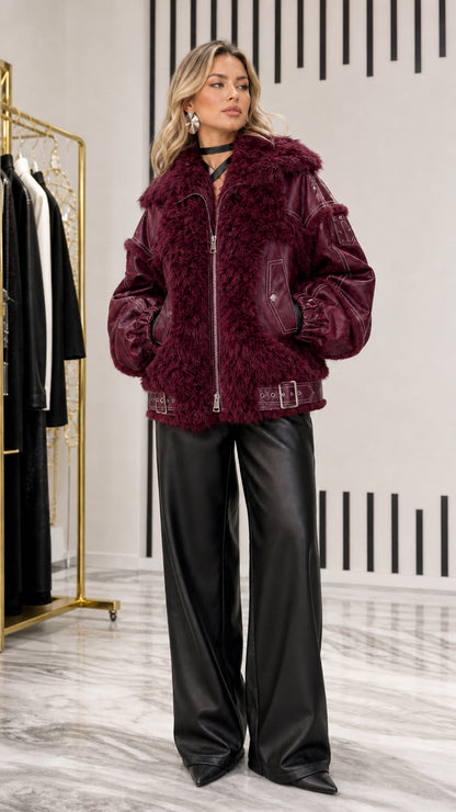 Model styled in deep burgundy wine faux leather and shearling zip-up jacket