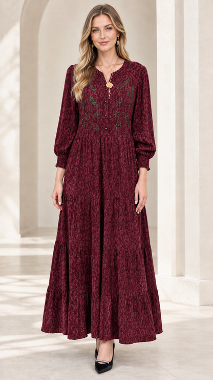 Front view of model wearing burgundy red embroidered tiered maxi dress