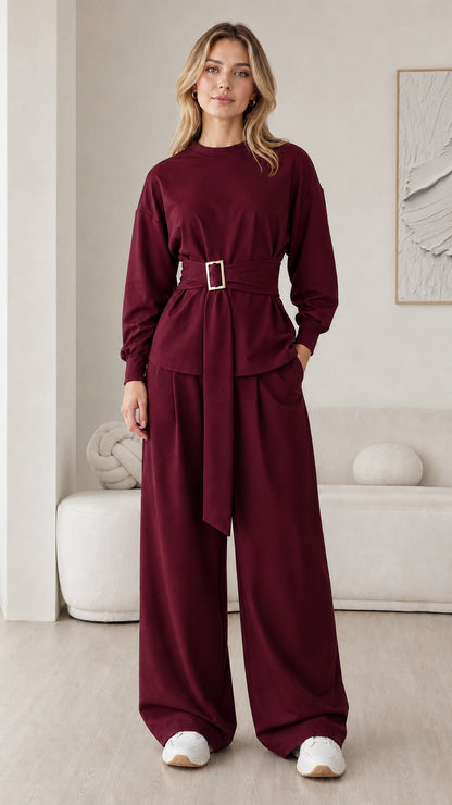 Model wearing deep burgundy belted long sleeve and wide leg lounge set