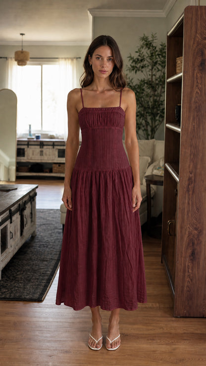 Woman wearing burgundy smocked midi dress