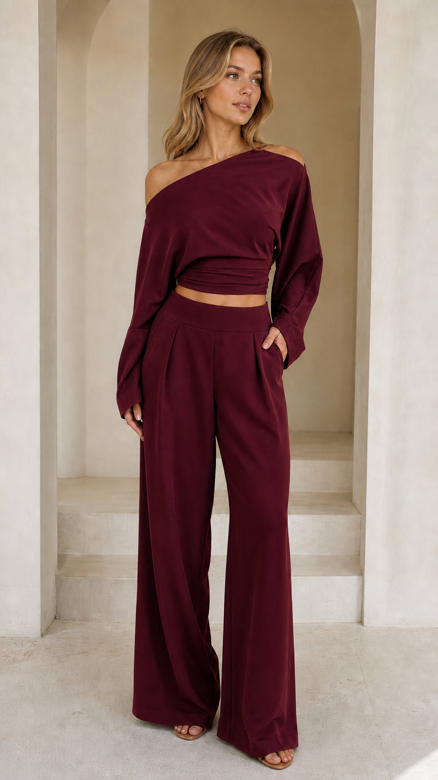 Full front view of model wearing burgundy off-shoulder crop top and wide-leg pant set