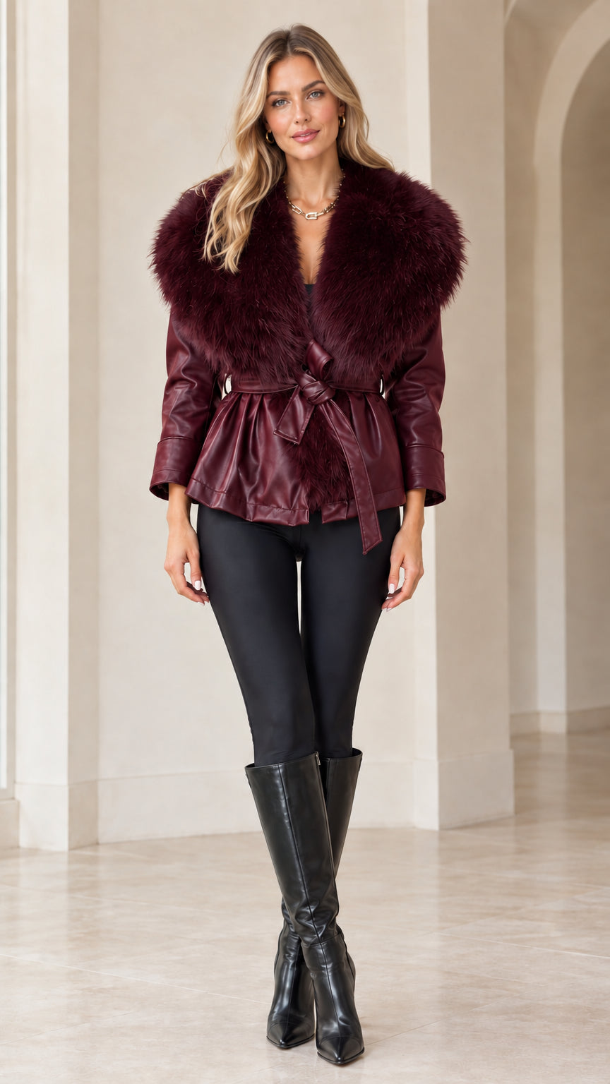 Front view of model wearing burgundy faux leather jacket with matching wine red faux fur collar