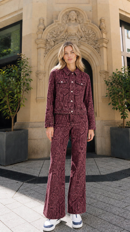 Full view of model wearing burgundy snake print denim matching set