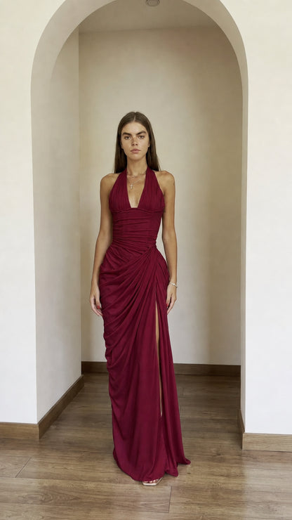 Front view of model wearing burgundy halter ruched maxi dress