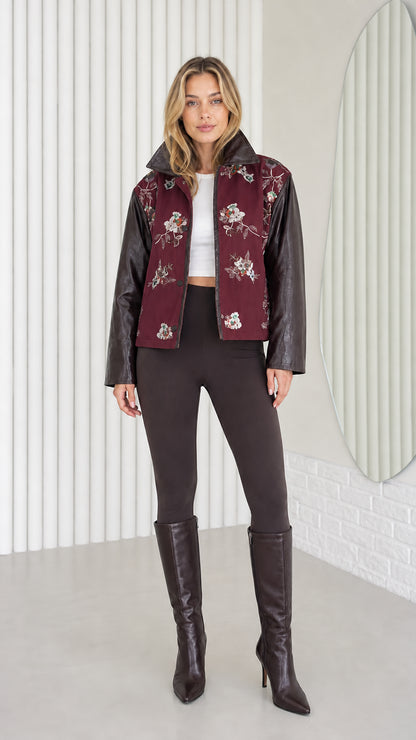 Model wearing Burgundy embroidered jacket with faux leather sleeves