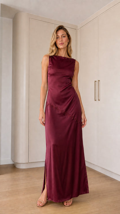 Front full-length view of model wearing burgundy sleeveless satin maxi dress