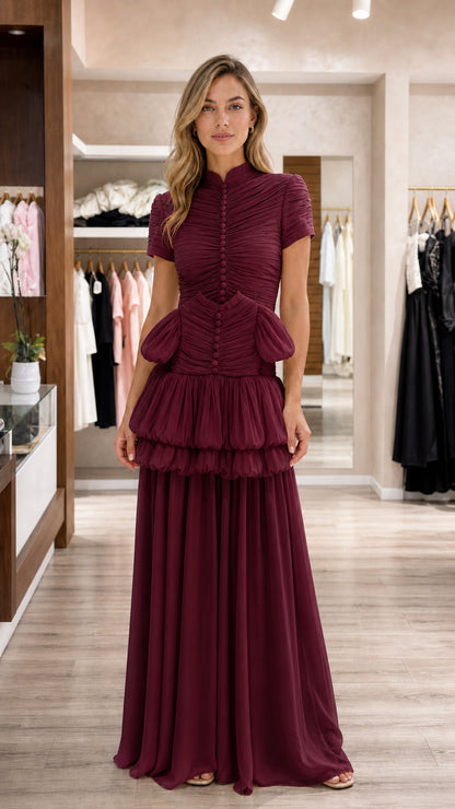 Model wearing burgundy wine tiered mock neck evening gown