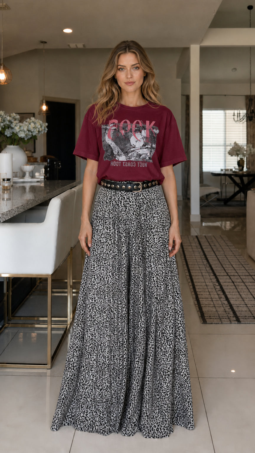 Model wearing burgundy graphic tee and leopard print pants