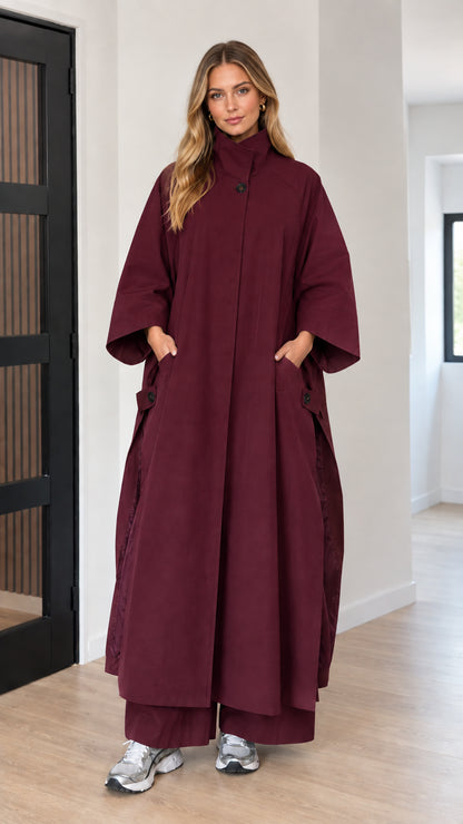 Front full-length view of woman wearing deep burgundy oversized maxi cape coat