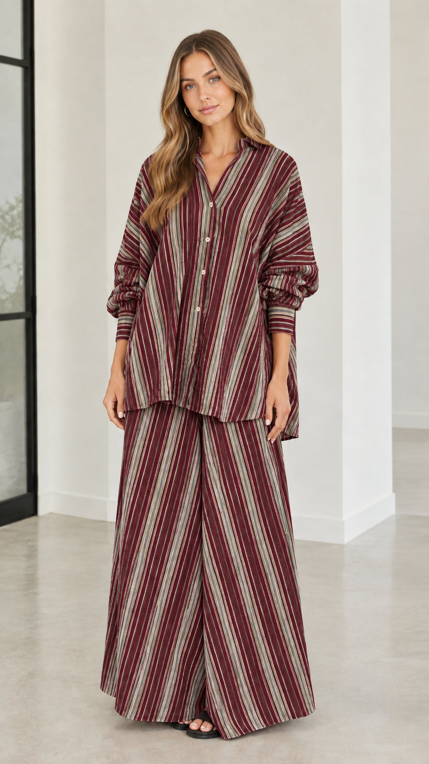 Model wearing burgundy and cream striped matching two-piece pant set