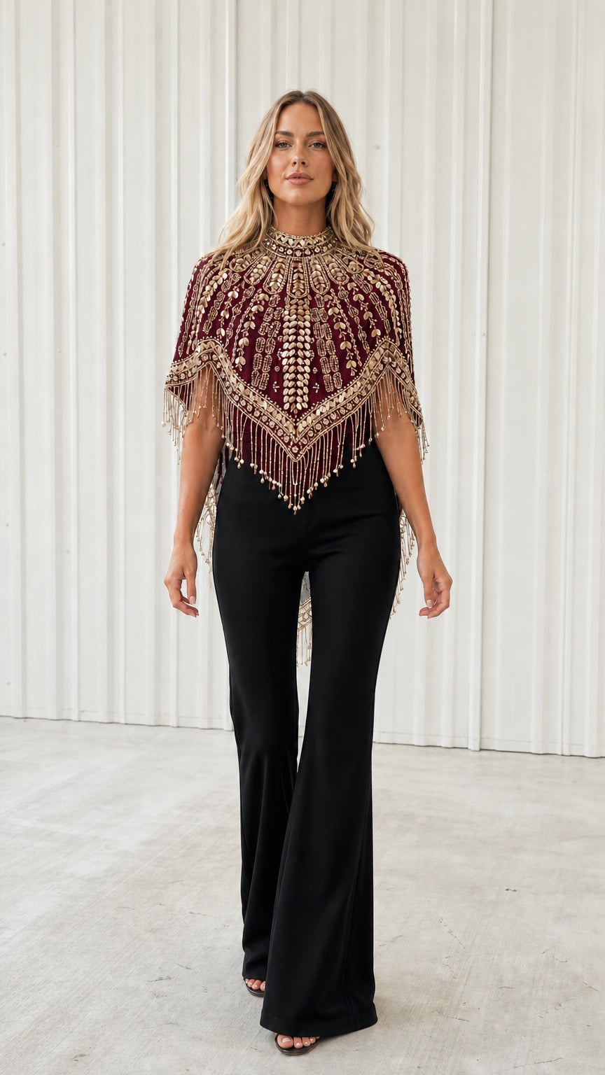 Front view of model wearing burgundy red beaded fringe evening capelet