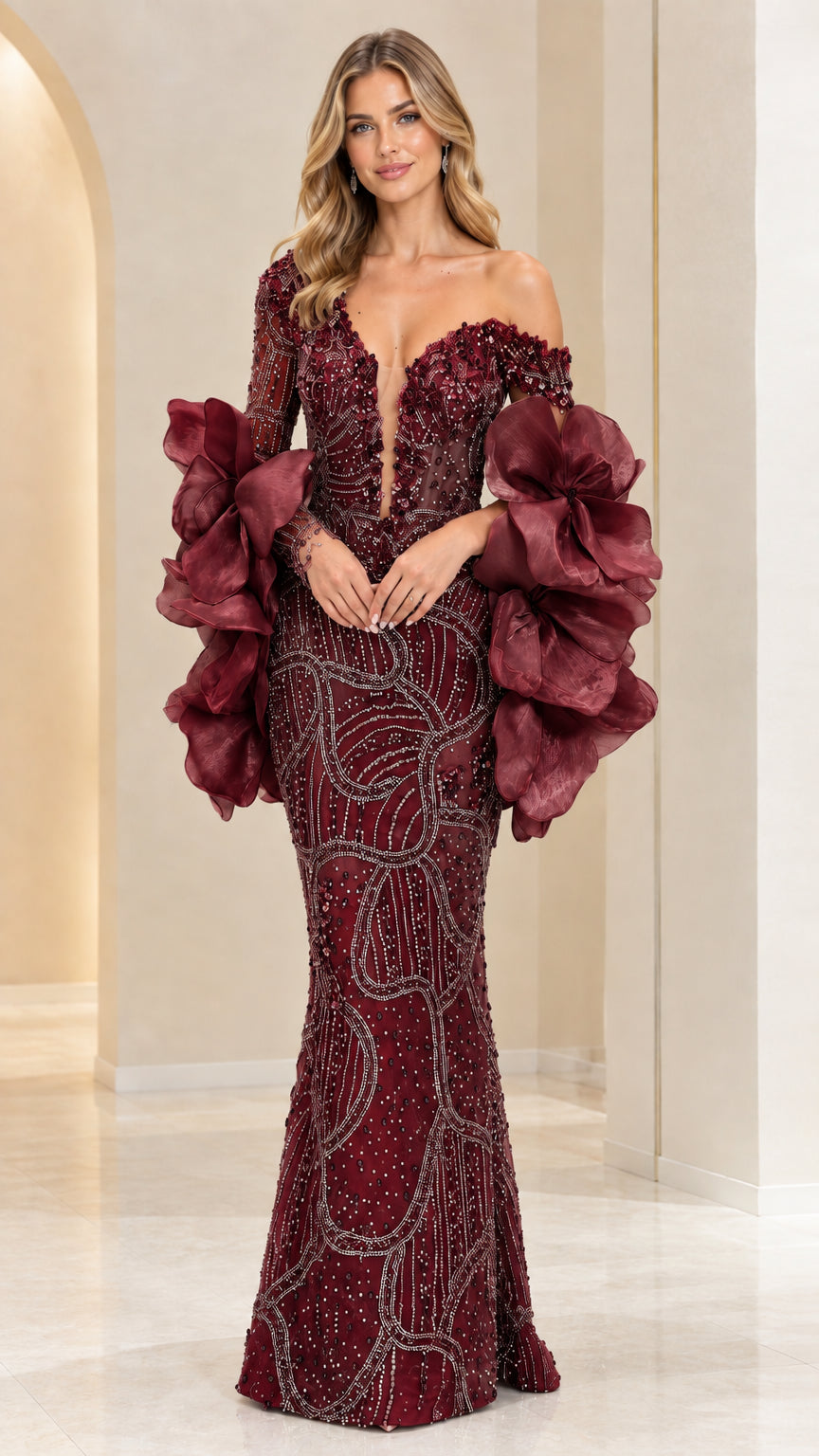 Model wearing Burgundy red crystal beaded mermaid gown with floral ruffle sleeves