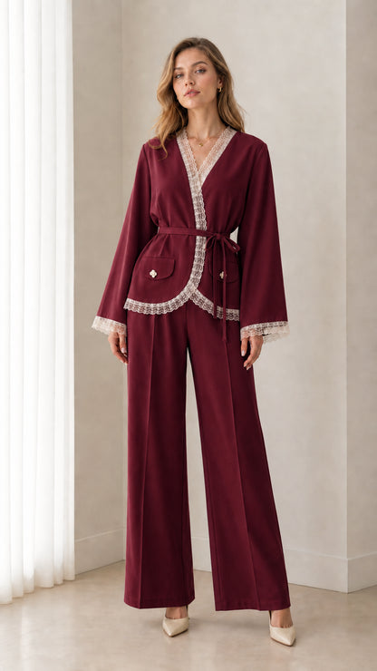 Front view of woman wearing burgundy wine wrap blazer and matching pants set