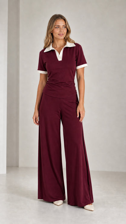 Model wearing Burgundy polo top and flowy wide-leg pants two-piece set
