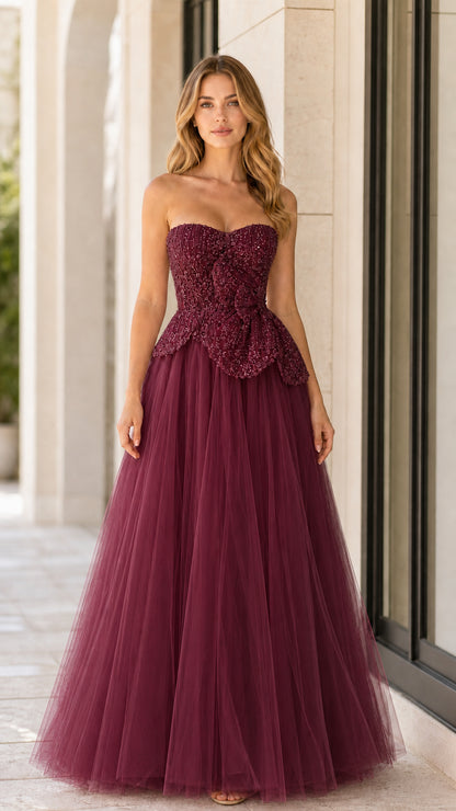 Front full-length view of burgundy strapless beaded tulle evening gown