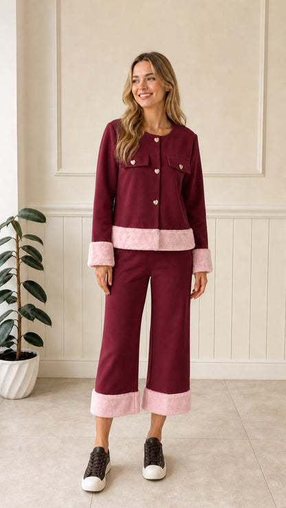 Front view of woman wearing burgundy jacket with pink faux fur trim and matching pants
