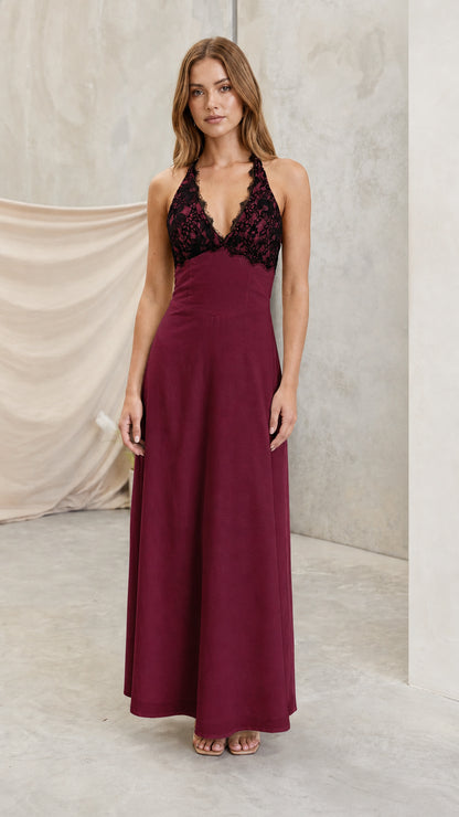 Model wearing burgundy wine halter maxi dress with dark lace bust