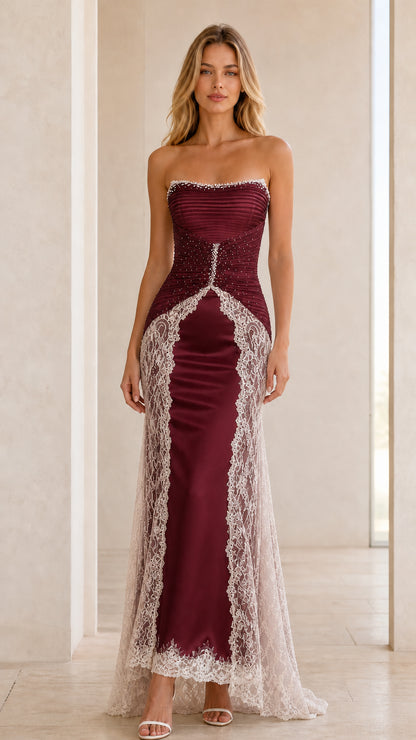 Front view of burgundy strapless satin maxi gown with lace overlay
