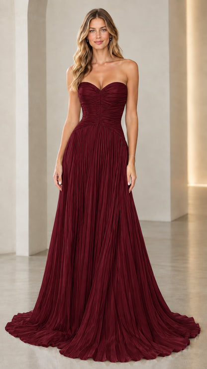 Model wearing burgundy red strapless sweetheart pleated evening dress