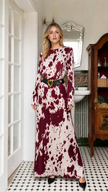 Woman wearing burgundy cow print long sleeve maxi dress with belt