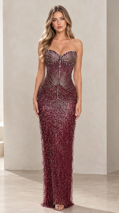 Woman wearing strapless burgundy wine red beaded fringe evening gown