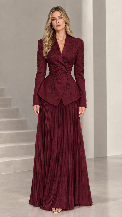 Full-length view of deep burgundy embroidered peplum blazer and pleated maxi skirt