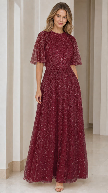 Woman wearing burgundy wine red sequin embroidered evening gown