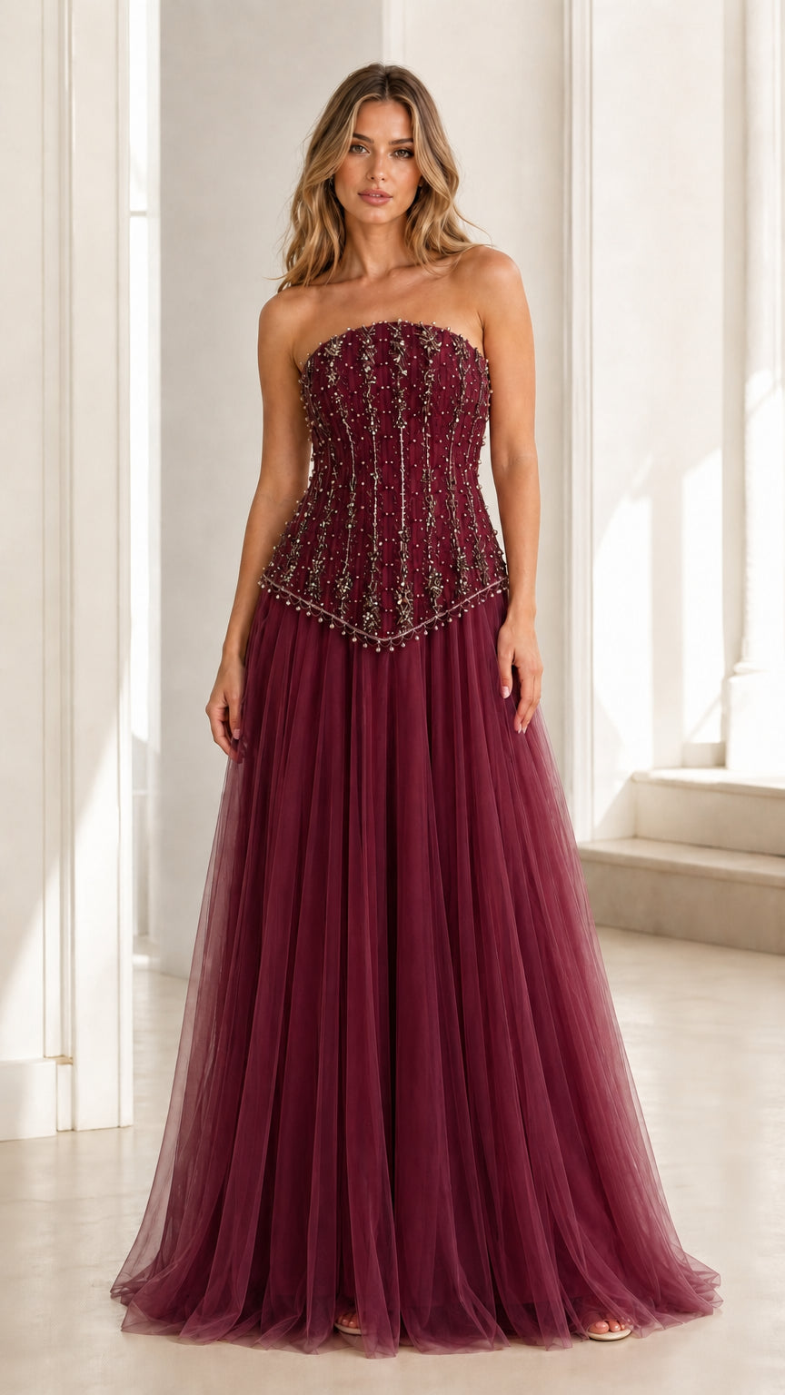 Front view of burgundy embellished strapless tulle evening gown