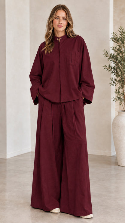 Front view of woman wearing the matching two-piece wide-leg set in burgundy
