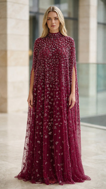 Model wearing burgundy wine red beaded cape evening gown