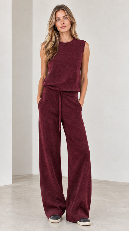Full-body view of woman wearing Burgundy sleeveless top and wide-leg knit pants set