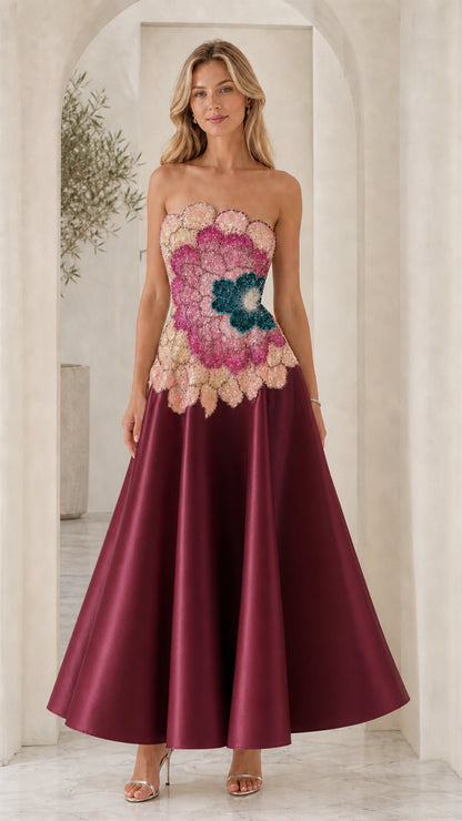 Model wearing burgundy variant of strapless evening dress