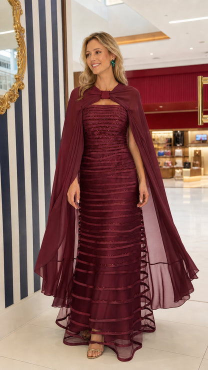 Full-length view of Burgundy wine red embellished cape evening dress