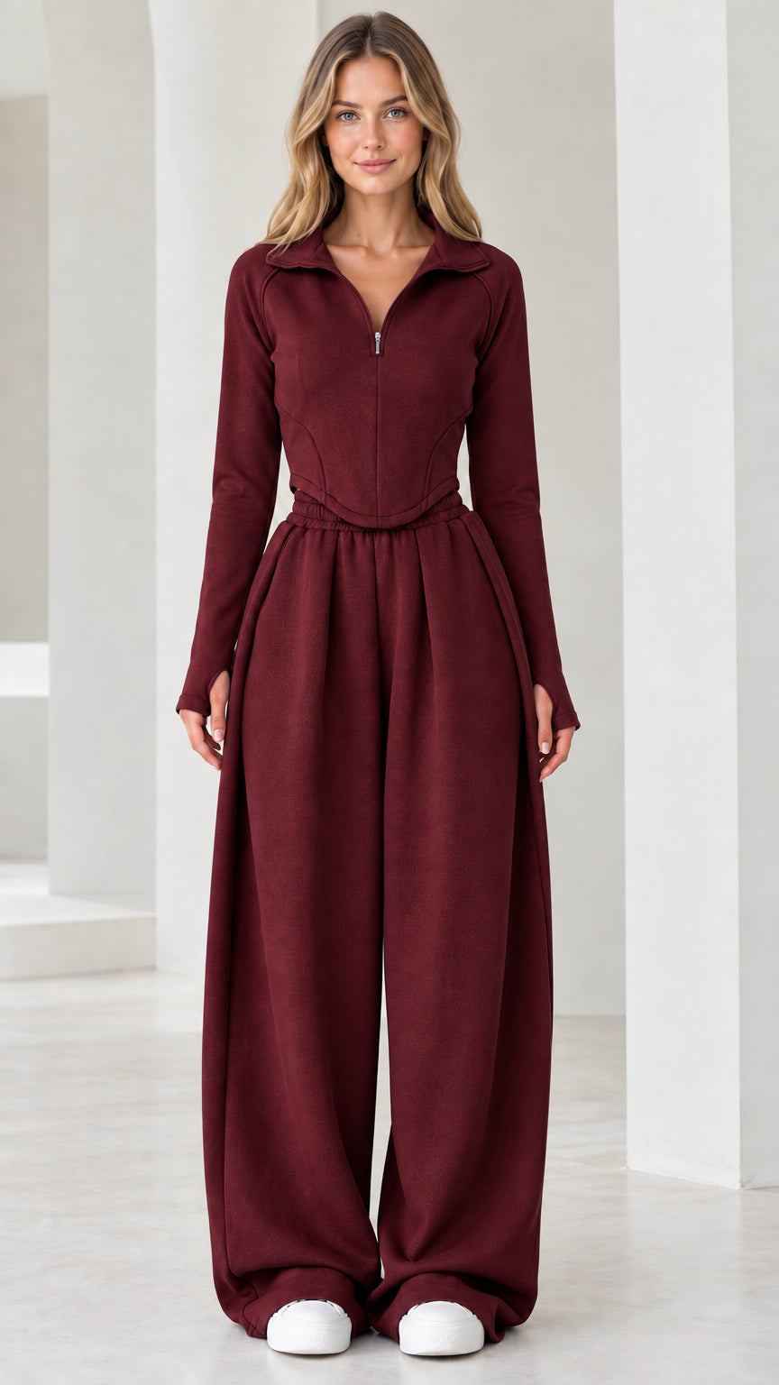 Full-length front view of model wearing burgundy red quarter-zip top and wide-leg pants set