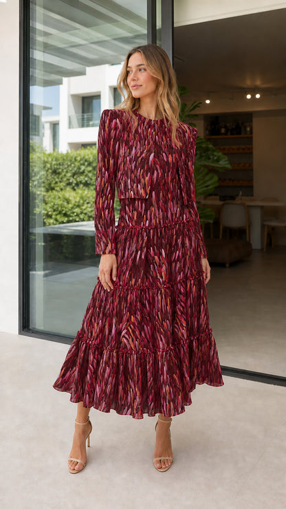 Model wearing burgundy abstract print tiered midi dress