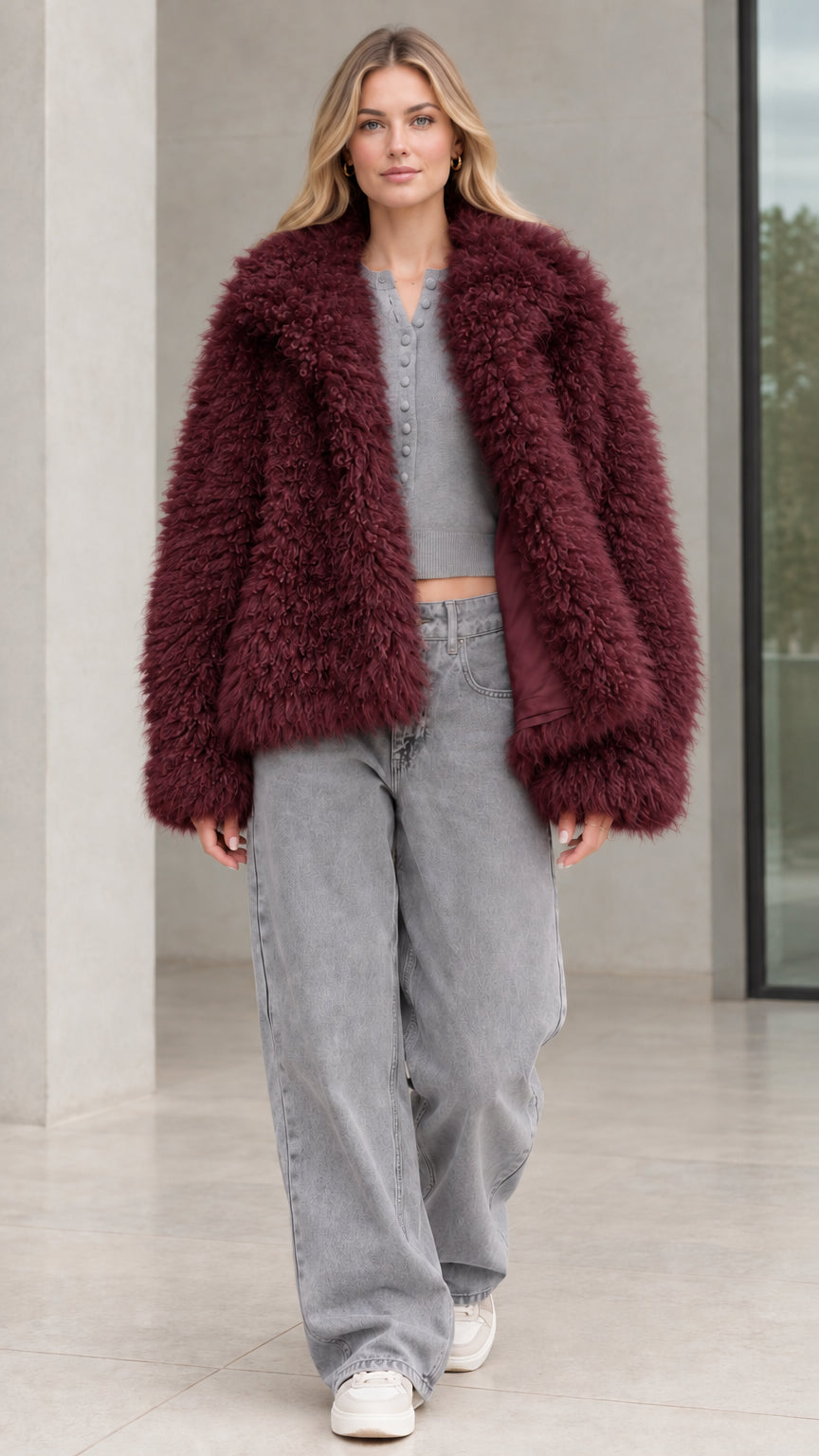 Front view of model wearing burgundy wine shaggy faux fur jacket