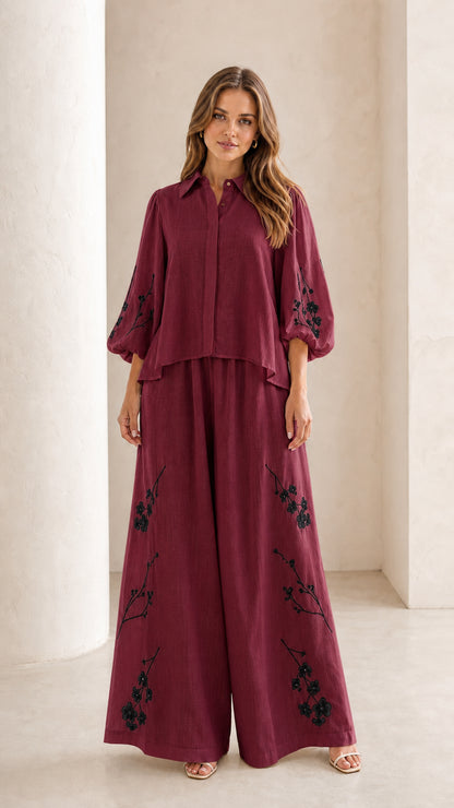 Front view of woman wearing burgundy wine floral embroidered two-piece set