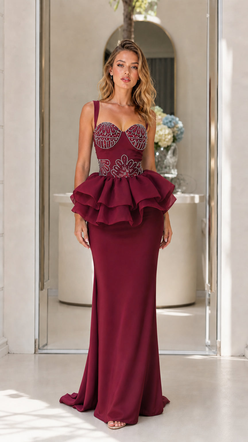 Front view of burgundy evening dress with structured peplum