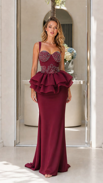 Front view of burgundy evening dress with structured peplum