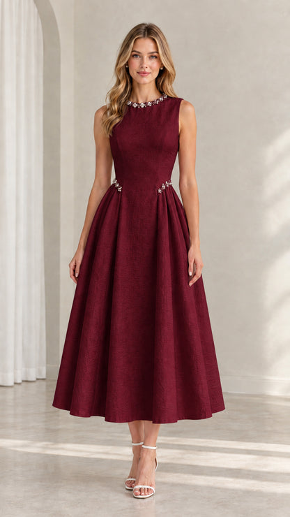 Model wearing burgundy red sleeveless pleated A-line midi dress