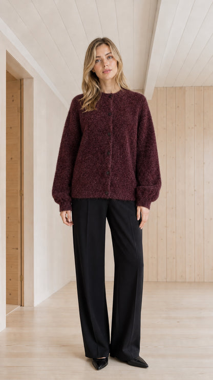 Model wearing burgundy fuzzy crewneck button-front cardigan sweater