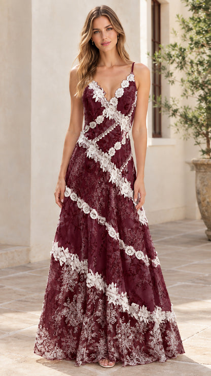 Woman wearing burgundy floral lace maxi dress with delicate trim