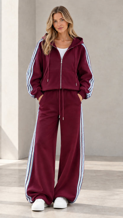Model wearing burgundy red zip-up hoodie and wide leg sweatpants loungewear set