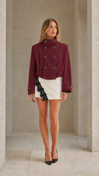 Front view of woman wearing burgundy wine cropped double-breasted trench jacket