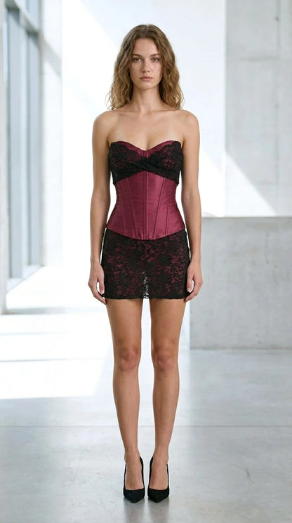 Front view of burgundy satin bustier and black lace mini skirt set