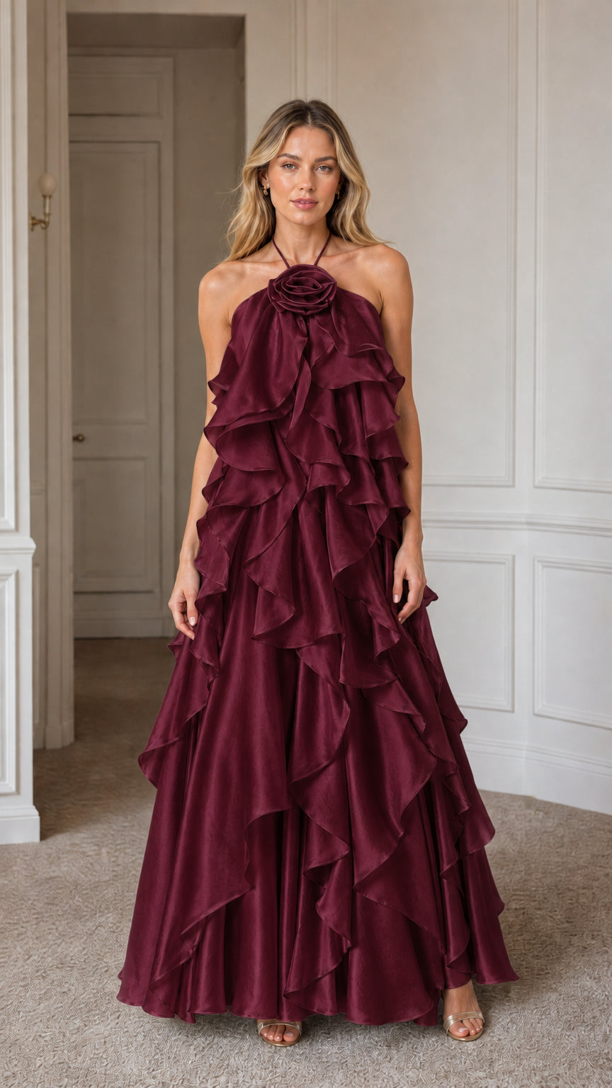 Model wearing deep burgundy formal ruffle gown