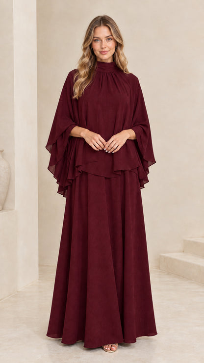 Model wearing deep burgundy mock neck cape maxi gown